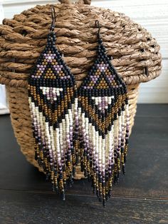 Handmade Brick Stitch Earring Using Toho Glass 11/0 Seed Beads Colors - Black, Purple, Cream & Gold Length Of Earring ( Not Including Earring Hook) - 5 Inches Width Of Widest Part - 1.25 Inches Beautiful Statement Earring! We always try to ship same day if possible! Bohemian Black Beaded Dangle Jewelry, Purple Bohemian Jewelry With Black Beads, Bohemian Purple Jewelry With Black Beads, Purple Beaded Fringe Jewelry For Festival, Purple Beaded Fringe Earrings For Festivals, Adjustable Bohemian Beaded Earrings With Black Beads, Festival Black Bead Drop Earrings, Bohemian Adjustable Beaded Earrings, Purple Festival Jewelry With Black Beads