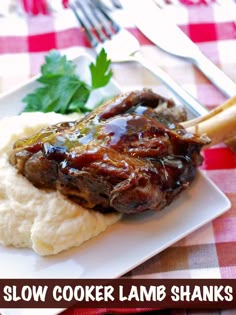 a white plate topped with meat and mashed potatoes