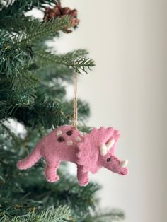 a pink ornament hanging from a christmas tree