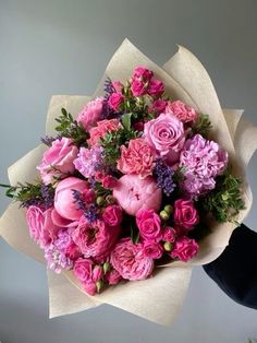 a bouquet of pink flowers on top of a table