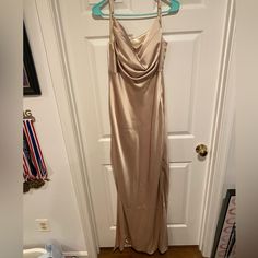 a dress hanging up on a door hanger