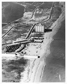 an aerial view of the beach and boardwalks in black and white, taken from above