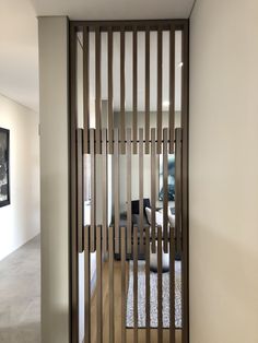 a living room with white walls and wooden slats