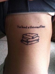 a woman with a tattoo that says i've lived a thousand lives on her thigh