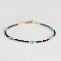 This super dainty bracelet is made up of tiny, sparkly black spinel faceted rondelles and beautiful genuine Arizona turquoise and metal accents in your choice of sterling silver, gold filled or rose gold filled.  This bracelet is sleek and elegant, and will look great on its own or with others.  Finished with a lobster clasp and findings.   This bracelet is very delicate - spinel stones measure about 2-2.5mm, and turquoise beads are about 3mm.  Bracelet measures 7 inches total, but I am happy to Elegant Turquoise Jewelry With Black Beads, Minimalist Silver Black Spinel Jewelry, Everyday Turquoise Hand-strung Stretch Bracelet, Turquoise Minimalist Hand-strung Bracelet, Black Spinel Bracelet, Elegant Turquoise Multi-stone Bracelets, Arizona Turquoise, Natural Gemstone Jewelry, Black Spinel