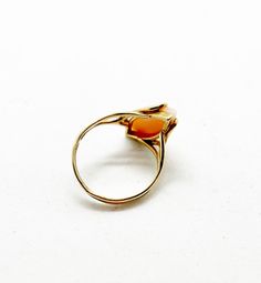 Beautiful 14k yellow gold ring in a vintage setting features a cabochon cut marquise pink Angel-skin Coral. The coral is securely set by 4 prongs at the points in the elongated navette shape setting. Marked 14kt. Size: 7 1/2 Can be sized up or down from your jeweler Measurements: Angelskin Coral 20mm X 7mm Classic Yellow Gold Oval Cabochon Moonstone Ring, Formal Orange Cabochon Ring, Classic Yellow Gold Cabochon Moonstone Ring, Classic Yellow Gold Moonstone Cabochon Ring, Formal 14k Gold Oval Cabochon Moonstone Ring, Vintage Yellow Gold Oval Moonstone Ring, Classic 14k Gold Moonstone Ring Oval Cabochon, Oval Moonstone Ring In 14k Gold For Formal Occasions, Formal Oval Moonstone Ring In 14k Gold