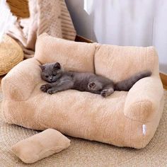 a cat laying on top of a fluffy chair