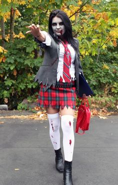 a woman dressed up as a zombie holding her hand out