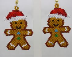 a pair of earrings made out of beads with a teddy bear wearing a santa hat