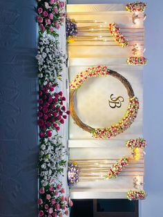 the wall is decorated with flowers, candles and an omesh symbol on it's side