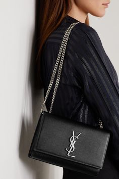 SAINT LAURENT's 'Kate' bag has been made in Italy from durable textured-leather that's punctuated with the label's iconic 'YSL' logo plaque. This compact style is sized to fit all the essentials and has a sliding chain strap that can either be worn on your shoulder or cross-body - tuck it away to carry yours as a clutch.    Wear it with: [SAINT LAURENT Shirt id1265074], [SAINT LAURENT Pants id1109779], [SAINT LAURENT Sandals id1265616]. Ysl Kate Bag Outfit, Ysl Kate Bag, Ysl Purse, Ysl Kate, Ysl Clutch, Saint Laurent Shirt, Kate Bags, Pretty Bags, Celine Bag