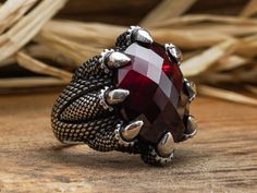 "Monster Claw Red Garnet Ring, Red Garnet Jewelry, Handmade Claw Ring, Silver Ring, Gift for Husband, Boyfriend Gift, Birthstone Gift Red garnet is said to be the stone of loyalty. It is believed to give energy. It is a great choice for a gift. It is a nice gift for girlfriend. It is a birthstone, it would be a nice choice for a birthday present. ❥ ITEM DETAILS You are looking at the high quality handcrafted silver ring. This ring is made of 925 sterling silver. All of my items has been designed Red Rings With Stones As A Gift, Red Rings With Stones For Gift, Unique Handmade Red Crystal Ring, Handmade Red Garnet Ring, Handmade Claw Jewelry As Gift, Man Jewellery, Red Garnet Jewelry, Red Garnet Ring, Eagle Claw