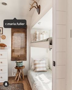 a bedroom with bunk beds and white walls