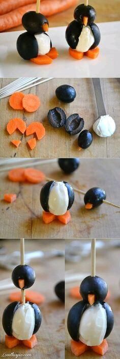 some kind of penguin made out of carrots and marshmallows on sticks