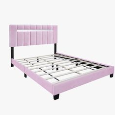 a pink bed frame with black legs and headboard is shown in front of a white background