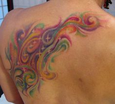 the back of a woman's colorful tattoo