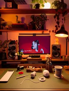 a flat screen tv sitting on top of a wooden table