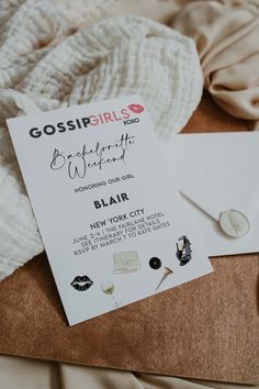 a white card with some pins on it sitting next to a pile of clothes and other items