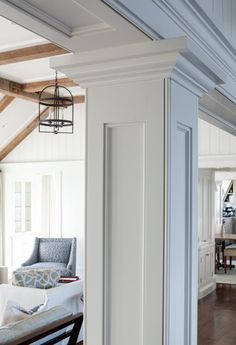 an open living room with white walls and wood floors