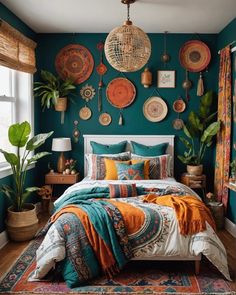 a bedroom decorated in teal, orange and white with lots of plates on the wall