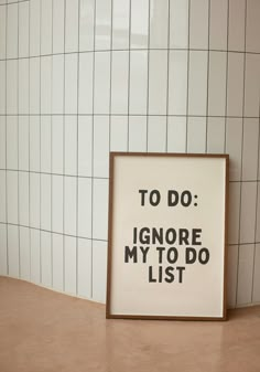 a sign that says to do ignore my to do list in front of a tiled wall