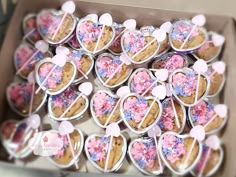 a box filled with heart shaped cookies covered in sprinkles