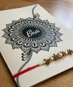 a greeting card with the word bhaj written on it and beaded tassels