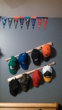 baseball caps and bats hanging on the wall