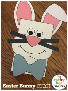 an easter bunny craft made out of paper on a wooden table with the words, easter bunny