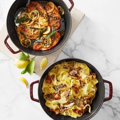 two pans filled with pasta and vegetables on top of a marble countertop next to each other