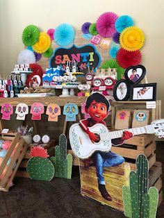 an image of a mexican day of the dead party with paper decorations and items on display