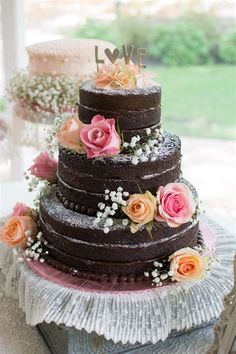 a three layer chocolate cake with flowers on top