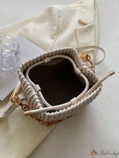 BirdinBag - Compact Pleated PU Mini Bucket Bag with Chain Embellishment Rectangular Bucket Bag With Chain Strap, Chic Rectangular Bucket Bag As Fashion Accessory, Beige Bucket Bag With Chain Strap, Beige Bucket Shoulder Bag With Chain Strap, Beige Shoulder Bucket Bag With Chain Strap, Gold Bucket Bag With Chain Strap, Chic Beige Bag With Chain Detail, Chic Beige Bag With Chain, Elegant Beige Bag With Chain Detail