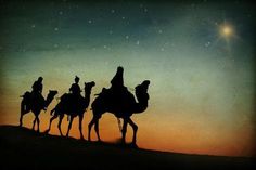 three people riding on camels in the desert at night with stars and sky behind them