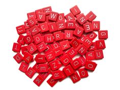 red wooden letters are arranged in the shape of a heart on a white background photo