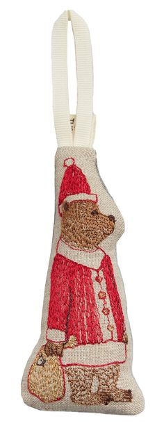 a christmas ornament with a bear wearing a santa hat and holding a bag