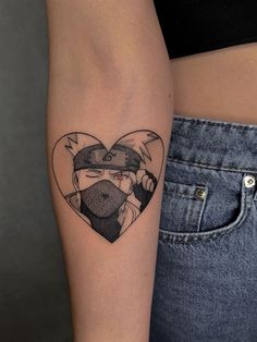 a woman's arm with a heart shaped tattoo on the left side of her body