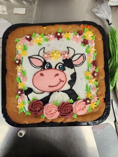 a cake decorated with a cow and flowers