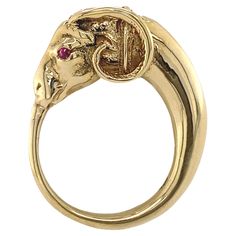 This striking figural ring is sort of a modified ouroboros -- the ancient round symbol of a snake eating its own tail -- only here the snake has the head of a ram. This whimsical mash-up of motifs puts it squarely in the mini-Etruscan revival of the 1940s and 1950s, when designs were informed by ancient artifacts, but didn't really have the imitative rigor of the first Etruscan Revival in the mid-19th Century. Substantial and gracefully proportioned, with outstanding detail at the head, this ram 1980s Retro Fashion, Snake Eating, Tiger Ring, Head Ring, Ring Mountings, Bow Ring, Oval Rings, The Snake, A Snake