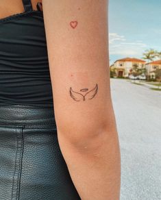 a woman with a small tattoo on her arm