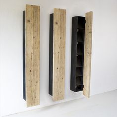 three wooden bookshelves mounted to the side of a wall