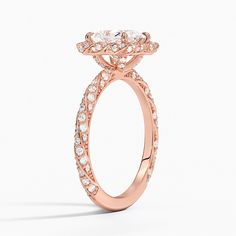 a rose gold engagement ring with diamonds on the side