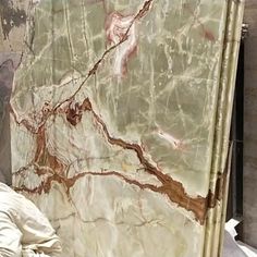 a large marble slab with brown and white designs on it's sides in a room