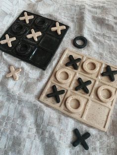 an assortment of toys like tic - tacs and doughnuts on a bed