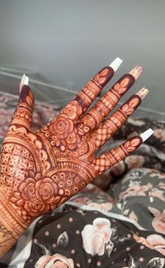 the hand is decorated with intricate designs on it