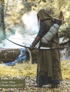 a person with a bow and arrow in the woods