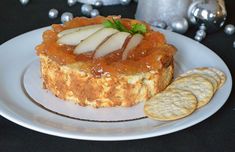 a dessert with pears and crackers on a plate