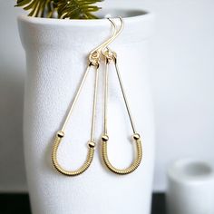 Upgrade your style with these stunning Harley Gold Coil Hoops. Long hoops crafted from 14k gold filled wire, these earrings feature a unique twist in the form of golden coils, for a look that's sure to turn heads. Wear them day or night for a dash of elegant, eye-catching flair! Approximately 2.25” long Made with 14k Gold Filled Polished to a high shine Handmade in Montana Sent in a ribboned gift box with polishing cloth Plastic Pouch, Gold Filled Hoops, Wire Earrings, Modern Earrings, Upgrade Your Style, Coils, Ear Wire, Long Earrings, Handmade Earrings