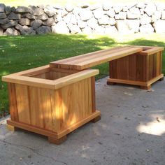 two wooden benches sitting next to each other on top of a cement floor near grass