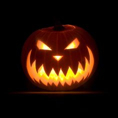 an illuminated jack o lantern in the dark